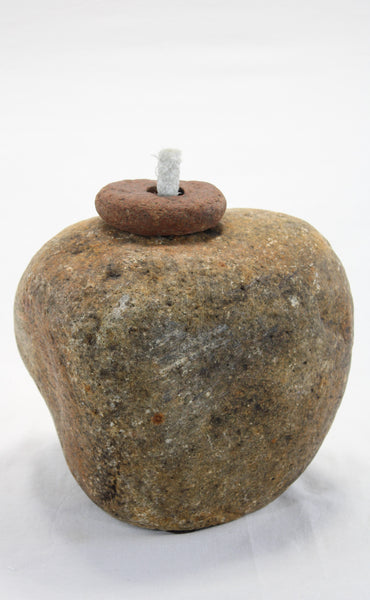 Yellow-brown granite stone tiki lamp with smooth texture and small top stone holding a half inch diameter wick.