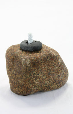 Brown granite stone tiki lamp with smooth texture and a small  round dark grey top stone holding  the wick.