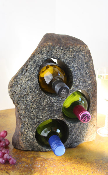 Grey-Brown Granite Stone Wine Rack holding 3 bottles of wine horizontally,  set atop a small table with red grapes and a glass of white wine.